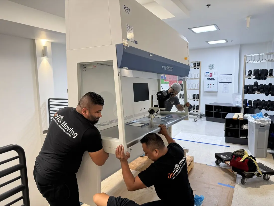 Ontrack Moving crew handling a biosafety cabinet on the second floor of a Bay Area biotech building during laboratory equipment moving