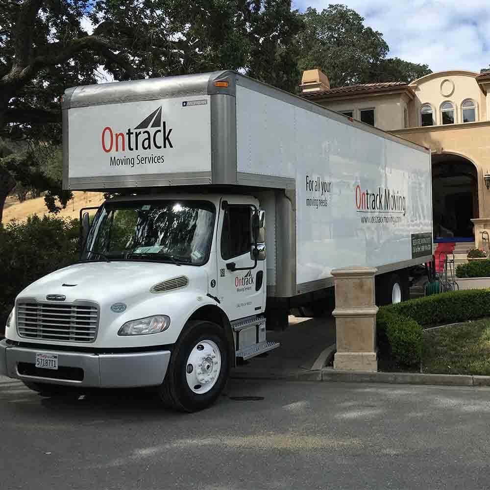 Ontrack Moving truck loading at residential mansion